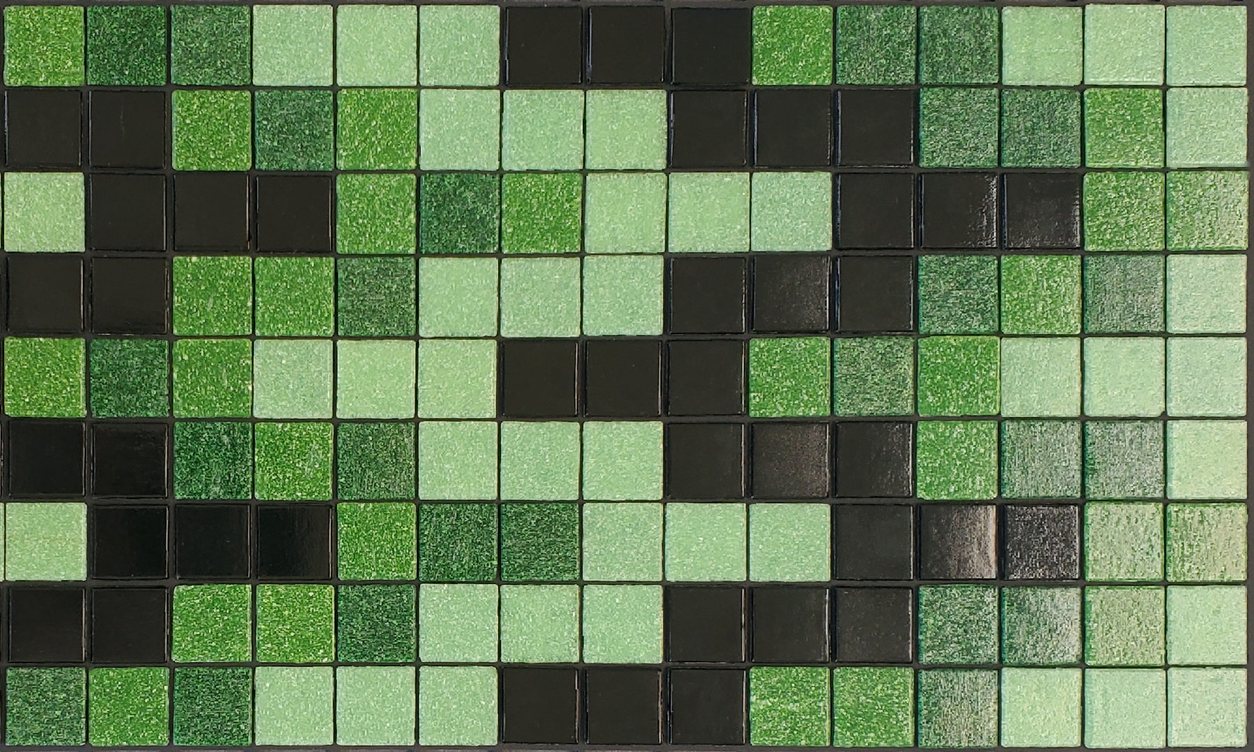 Bargello M - glass mosaic waterline pool border tile - glossy black, bright green and light green in a rhythmic, undulating pattern. 
