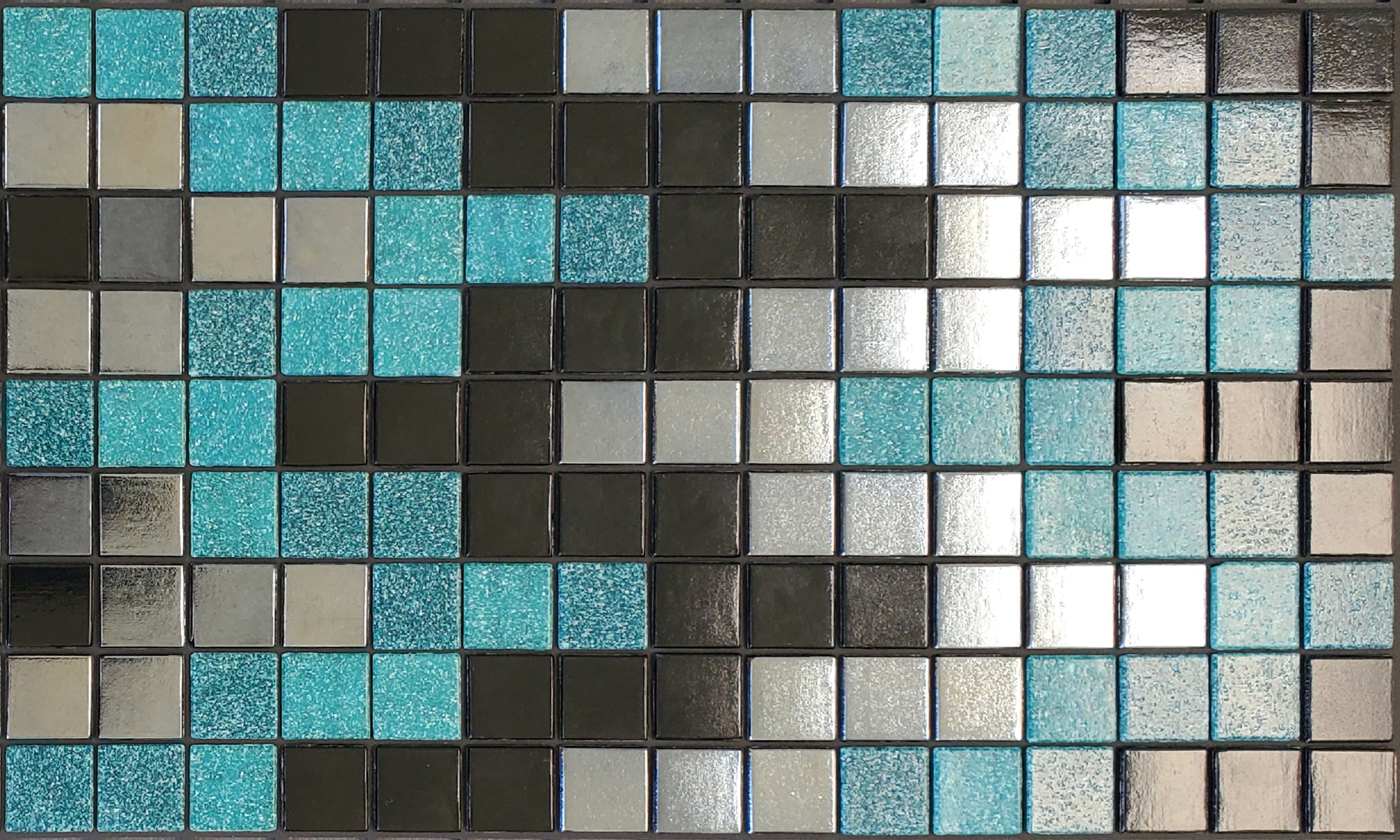 Bargello Q - glass mosaic waterline pool border tile - glossy black, teal and metallic silver in a rhythmic, undulating pattern. 