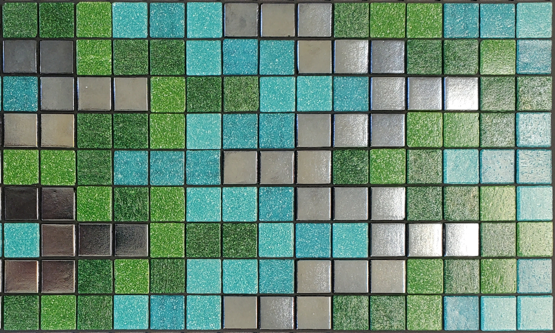 Bargello S - glass mosaic waterline pool border tile - green, teal and metallic silver tile in a rhythmic, undulating pattern. 