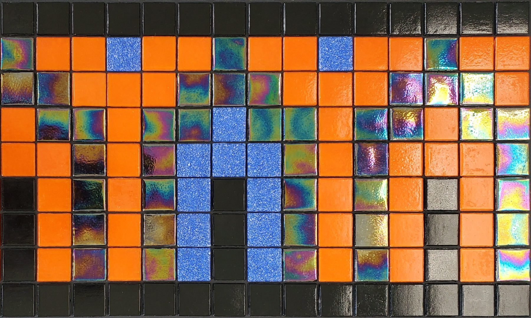 Marrakech A - Moroccan-inspired glass mosaic waterline pool border tile - glossy black surrounds orange, blue and iridescent archways.