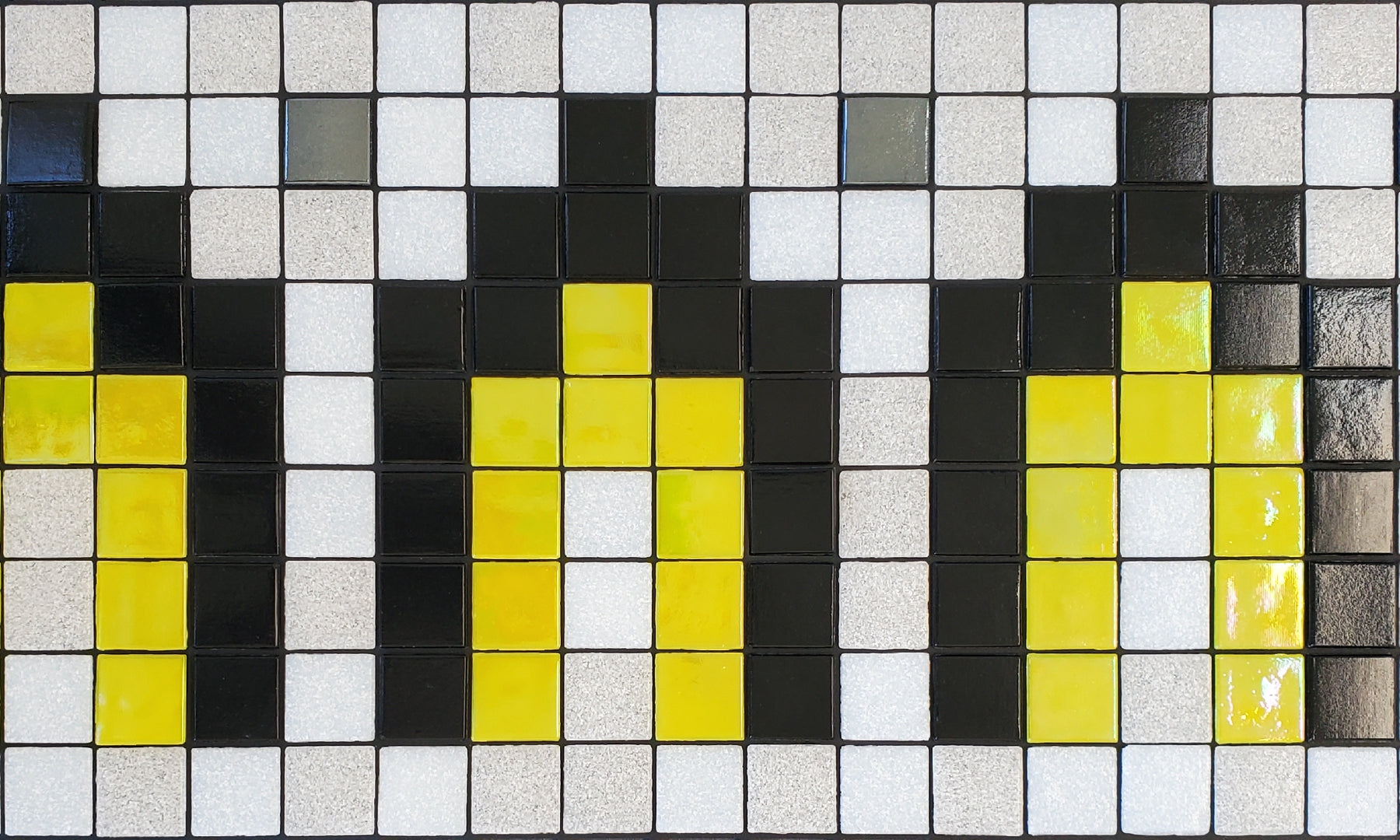 Marrakech AL - Moroccan-inspired glass mosaic waterline pool border tile - glossy black and iridescent yellow archways surrounded by white with metallic silver dot accents.