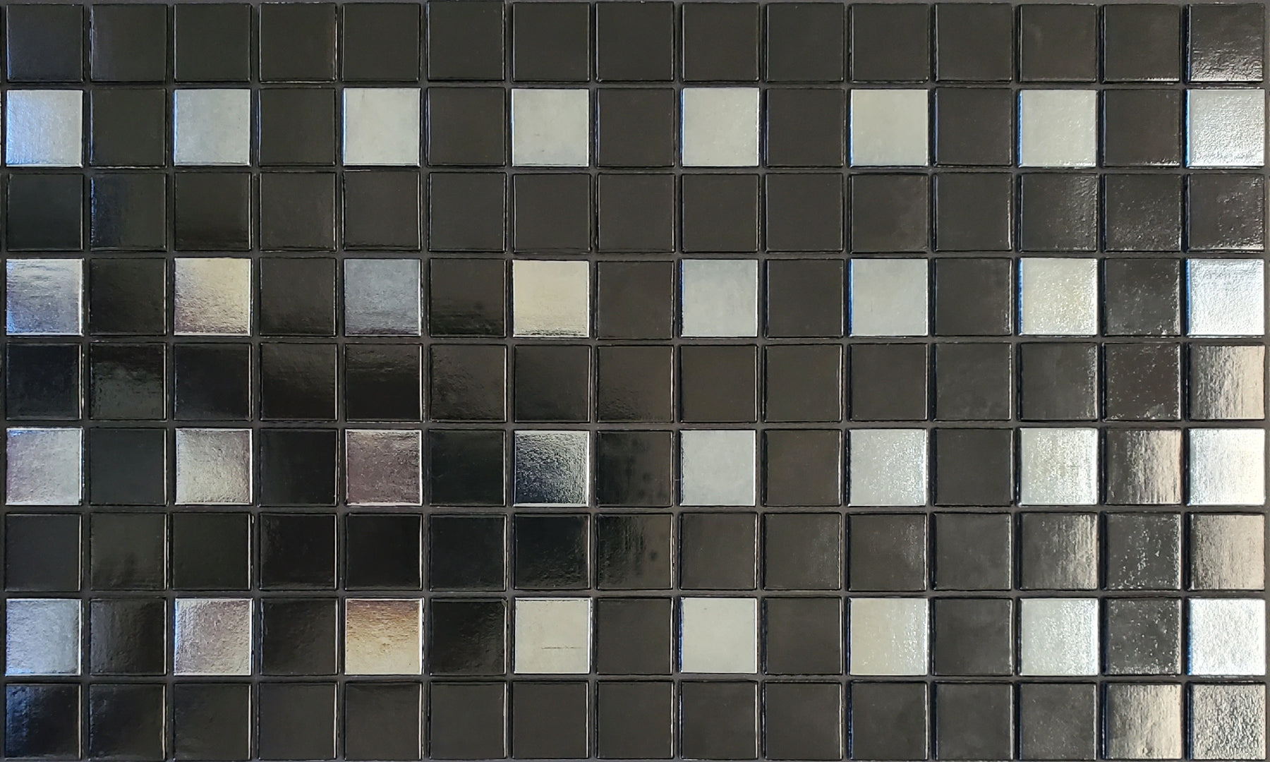 Parker C - modernism-inspired checkerboard glass mosaic waterline pool border tile - glossy black and metallic silver tiles in a punctuated grid.
