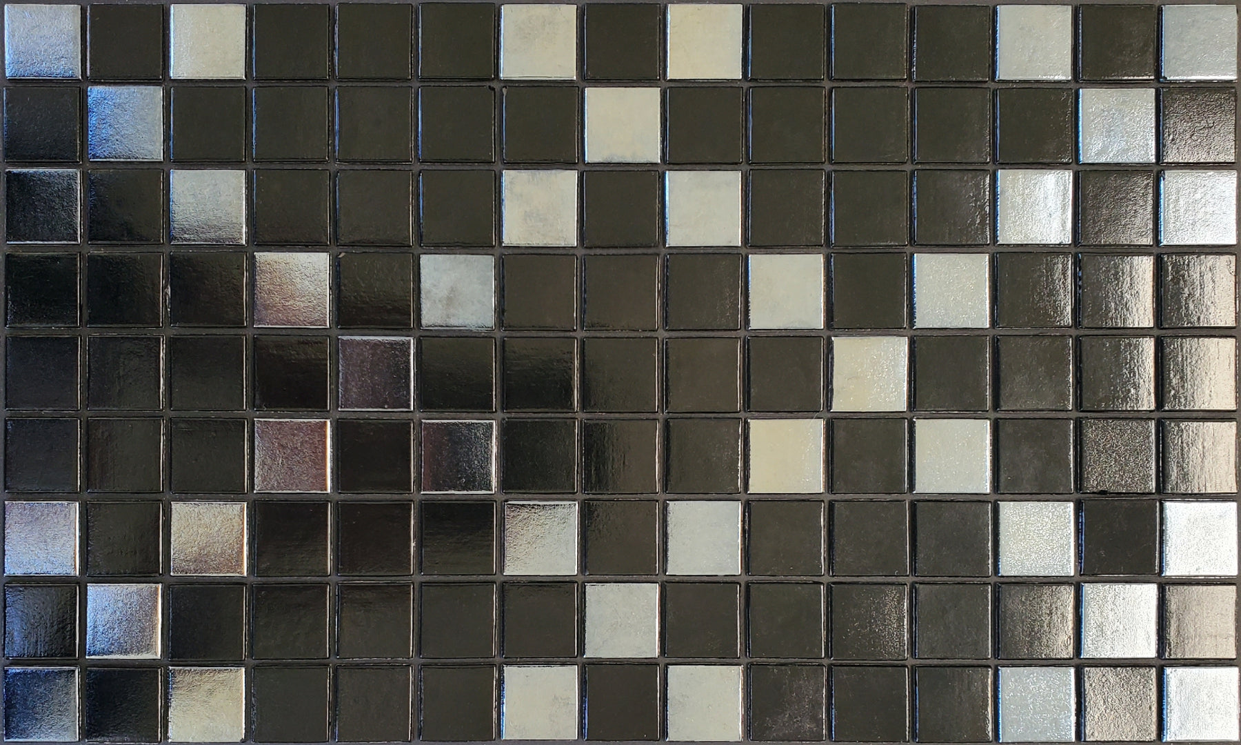 Souk  Q - Moroccan-inspired glass mosaic waterline pool border tile - glossy black and metallic silver in an "x" pattern.