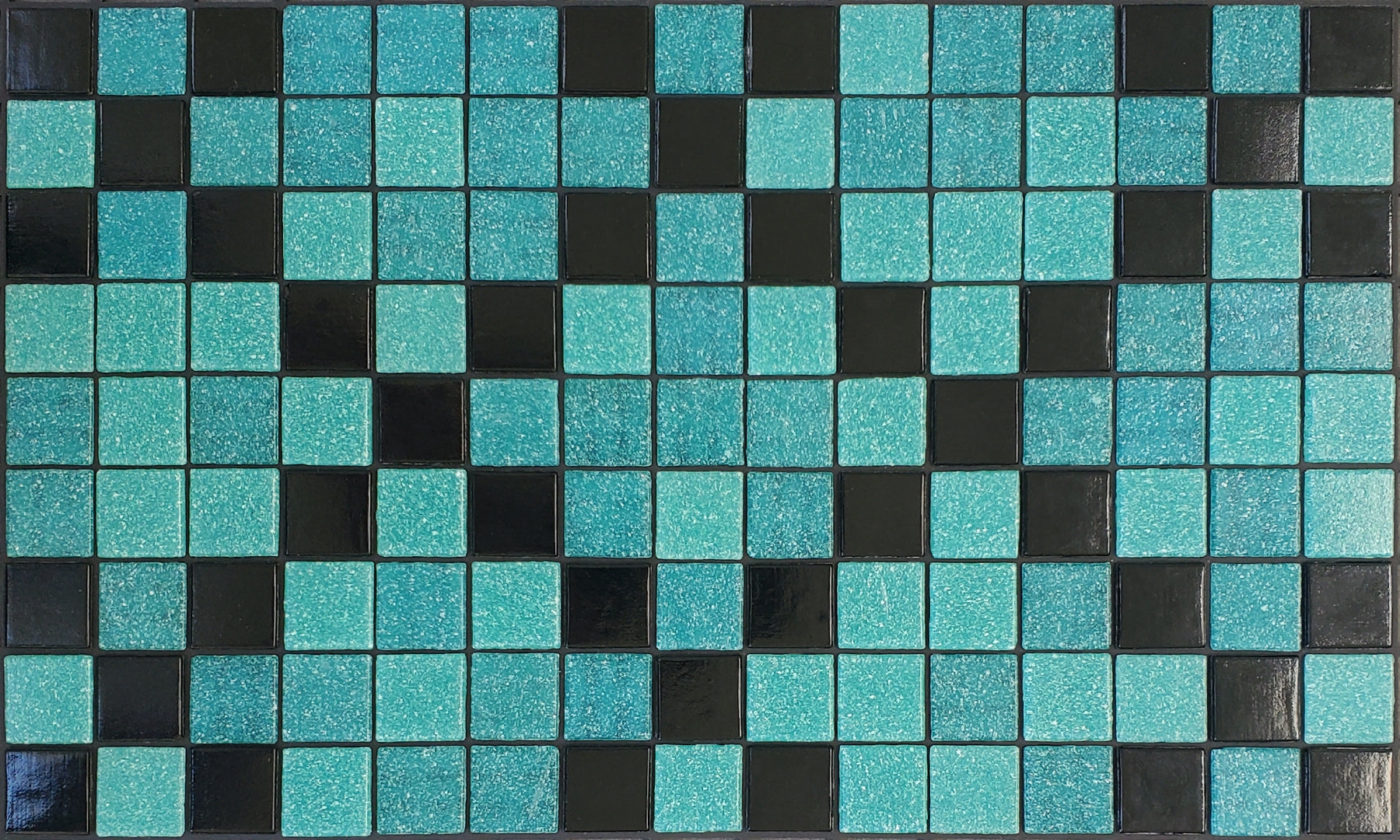 Souk Z - Moroccan-inspired glass mosaic waterline pool border tile - glossy black and teal tiles in an "x" pattern.